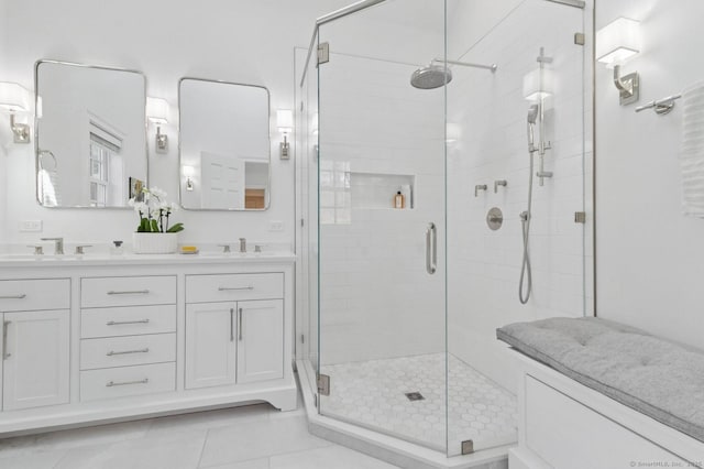 full bathroom featuring a shower stall, double vanity, and tile patterned floors