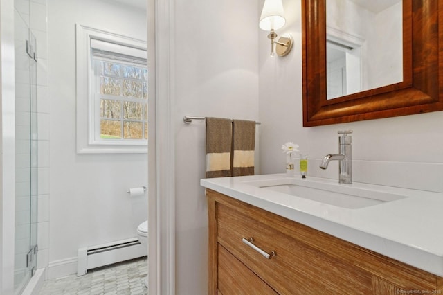 bathroom featuring baseboard heating, toilet, vanity, baseboards, and an enclosed shower