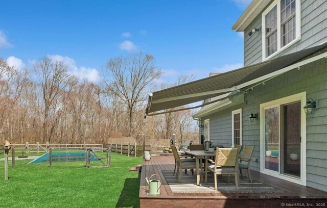 view of yard with a wooden deck and outdoor dining space