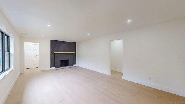 101 Parade Hill Rd, New Canaan, CT 06840 - unfurnished living room with light wood finished floors, a fireplace, baseboards, and recessed lighting