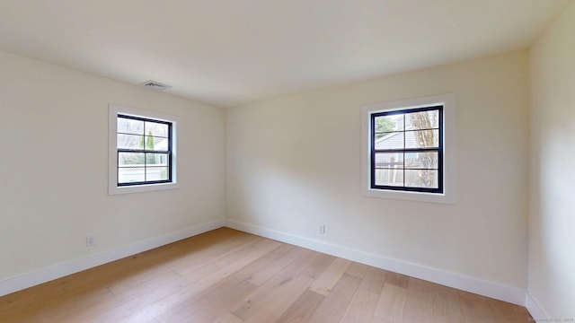 101 Parade Hill Rd, New Canaan, CT 06840 - empty room featuring light wood-style floors, baseboards, visible vents, and a healthy amount of sunlight