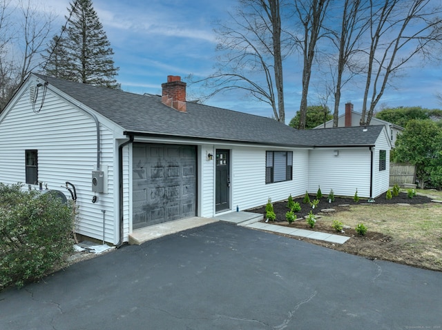 101 Parade Hill Rd, New Canaan, CT 06840 - view of front facade featuring roof with shingles, driveway, a chimney, and an attached garage