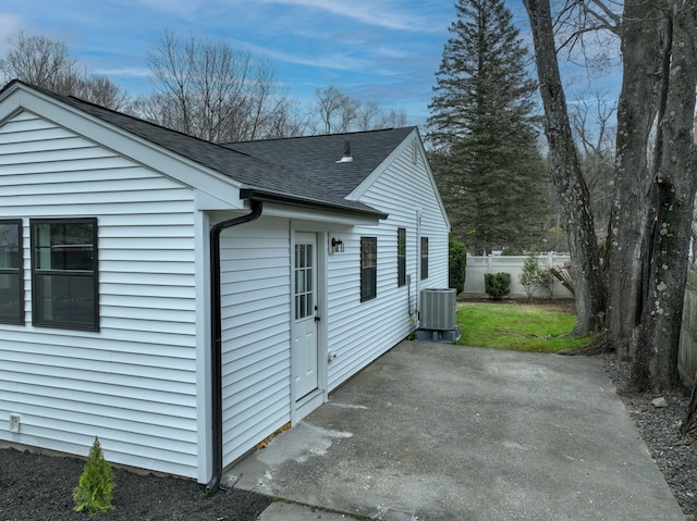 101 Parade Hill Rd, New Canaan, CT 06840 - view of side of property featuring central AC unit, fence, a patio, and roof with shingles