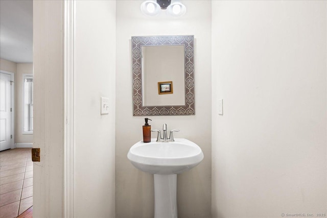 bathroom featuring tile patterned flooring and a sink