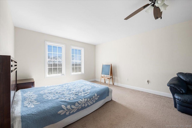 carpeted bedroom featuring baseboards and a ceiling fan