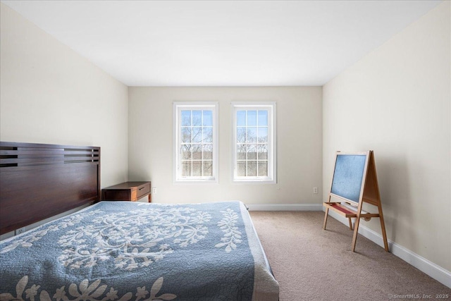 carpeted bedroom featuring baseboards