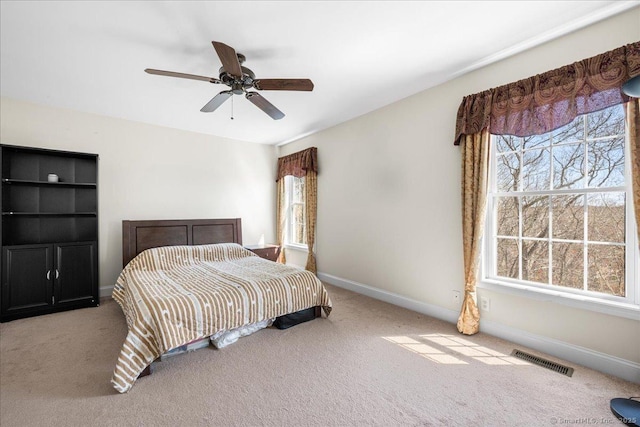 bedroom with baseboards, visible vents, carpet, and ceiling fan