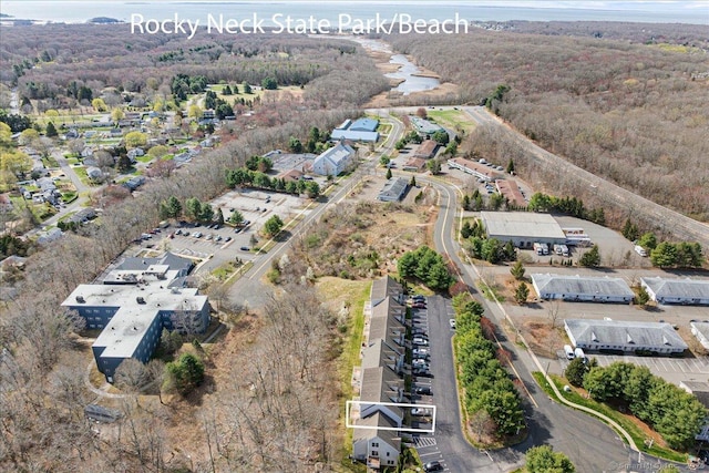 bird's eye view with a wooded view