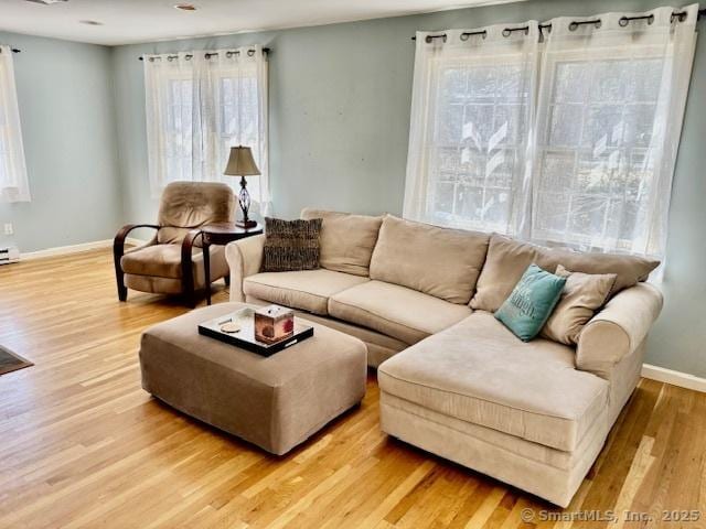 living room featuring light wood-style flooring and baseboards
