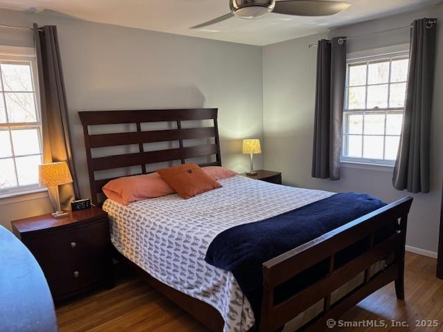 bedroom featuring baseboards, a ceiling fan, and wood finished floors
