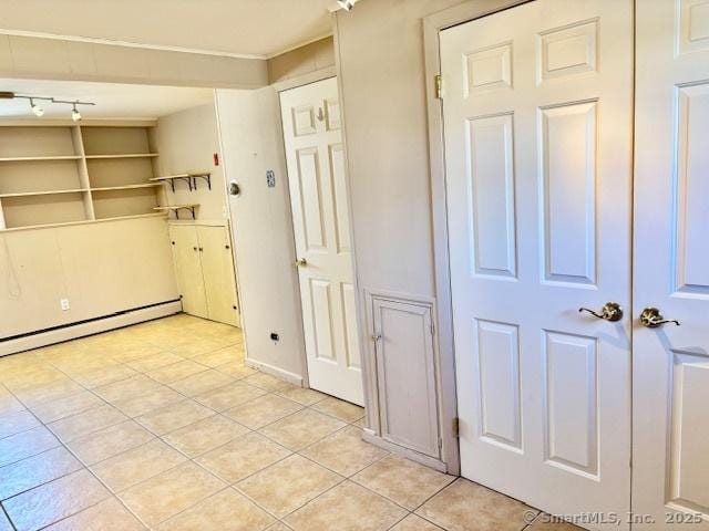 interior space featuring a baseboard radiator and light tile patterned flooring