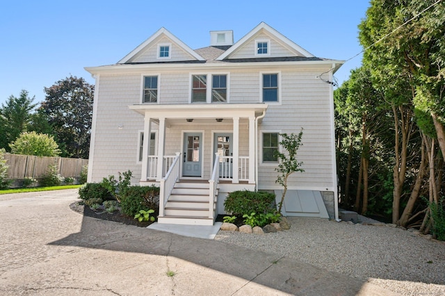 56-58 E Main St, Stonington, CT 06355 - view of front of home featuring driveway, fence, and covered porch