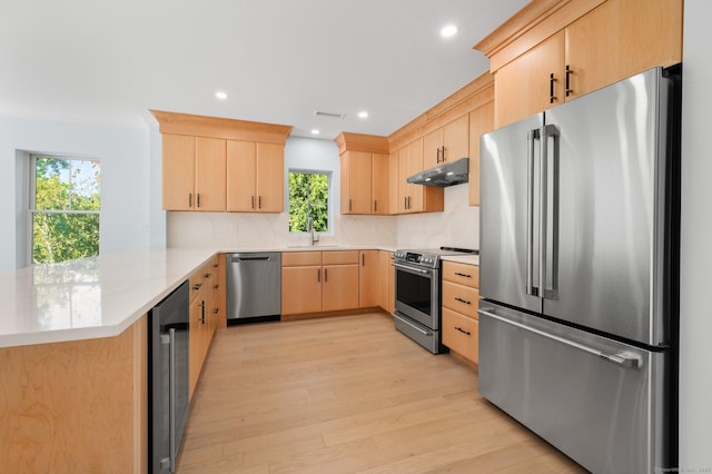 56-58 E Main St, Stonington, CT 06355 - kitchen featuring light brown cabinets, a sink, appliances with stainless steel finishes, a peninsula, and under cabinet range hood