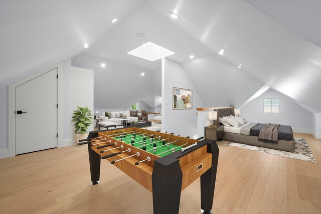 56-58 E Main St, Stonington, CT 06355 - playroom featuring light wood finished floors, baseboards, and lofted ceiling with skylight