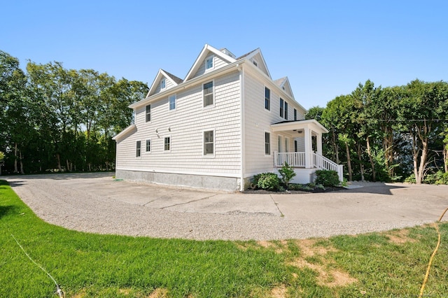 56-58 E Main St, Stonington, CT 06355 - view of side of property featuring a porch and a lawn