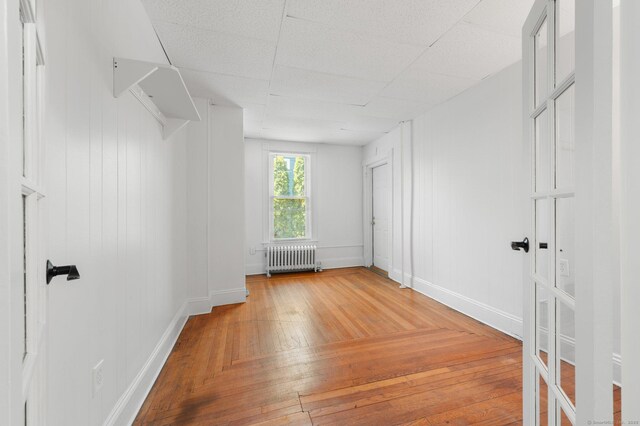 56-58 E Main St, Stonington, CT 06355 - unfurnished bedroom featuring light wood-style flooring, baseboards, and radiator
