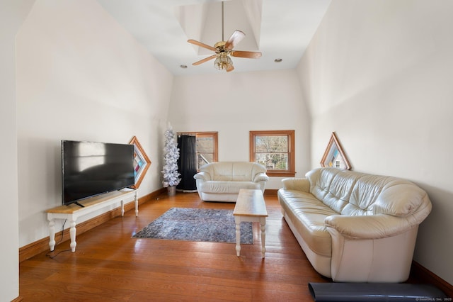 56-58 E Main St, Stonington, CT 06355 - living room featuring wood finished floors, baseboards, a ceiling fan, and a towering ceiling