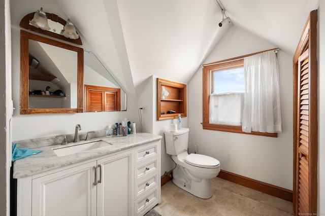 56-58 E Main St, Stonington, CT 06355 - bathroom featuring toilet, vanity, baseboards, and vaulted ceiling