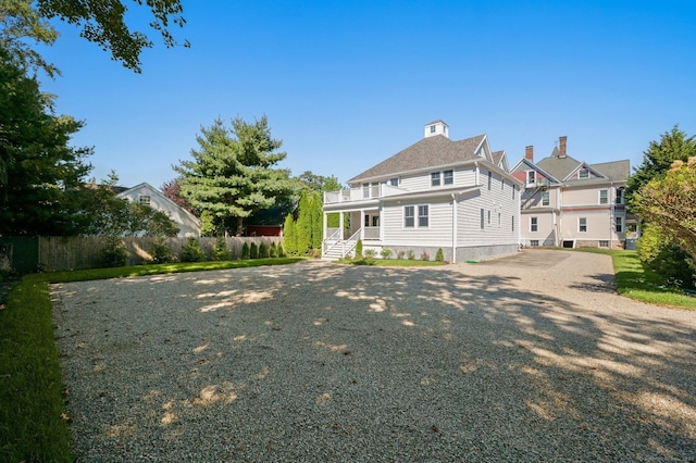 56-58 E Main St, Stonington, CT 06355 - back of property featuring roof with shingles and fence