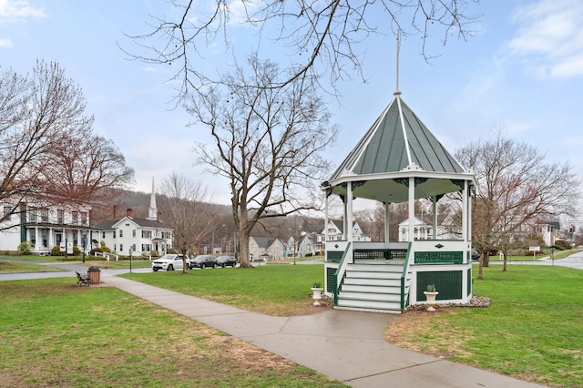 view of property's community with a residential view, a gazebo, and a lawn