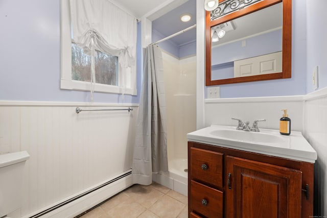 full bath with vanity, tile patterned flooring, a wainscoted wall, baseboard heating, and curtained shower