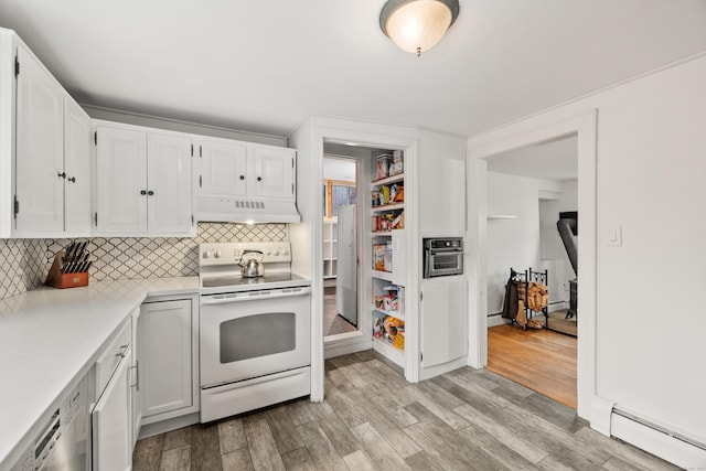 kitchen featuring white electric range oven, white cabinets, under cabinet range hood, a baseboard heating unit, and light countertops