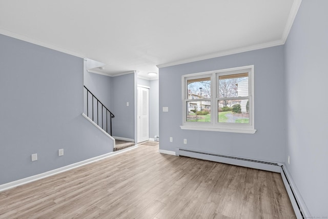 unfurnished living room featuring a baseboard radiator, wood finished floors, and ornamental molding