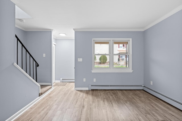 entryway with wood finished floors, a baseboard heating unit, and ornamental molding
