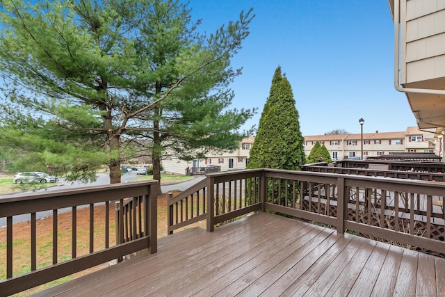 wooden terrace featuring a residential view