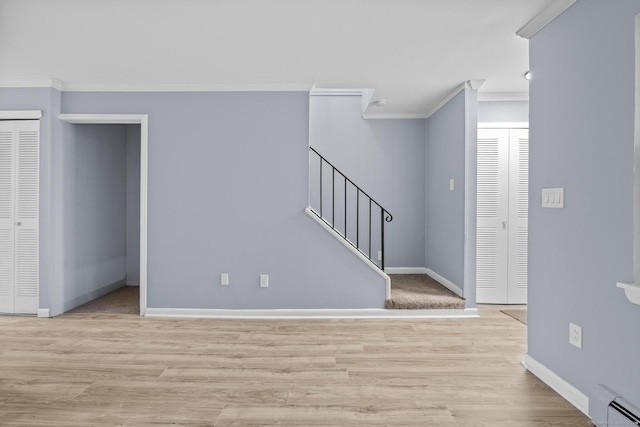 entrance foyer with crown molding, wood finished floors, and baseboards