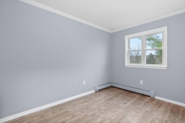 empty room with baseboards, baseboard heating, light wood-type flooring, and crown molding