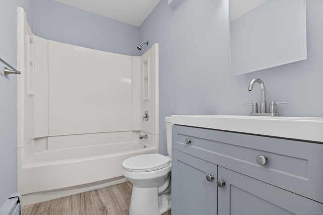 full bathroom featuring vanity, toilet, shower / bath combination, wood finished floors, and a baseboard radiator