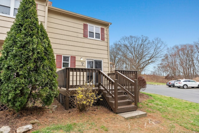 rear view of house with a wooden deck