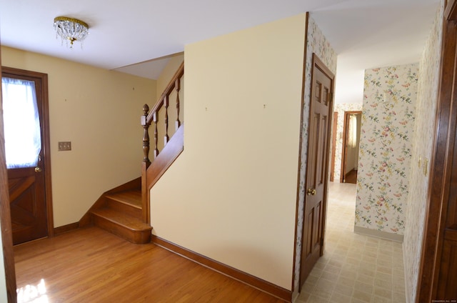stairs with baseboards and wood finished floors