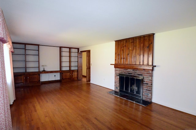 unfurnished living room with a fireplace and wood finished floors