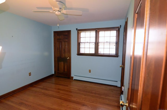 15 Burnwood Dr, Bloomfield, CT 06002 - spare room with baseboard heating, wood finished floors, a ceiling fan, and baseboards