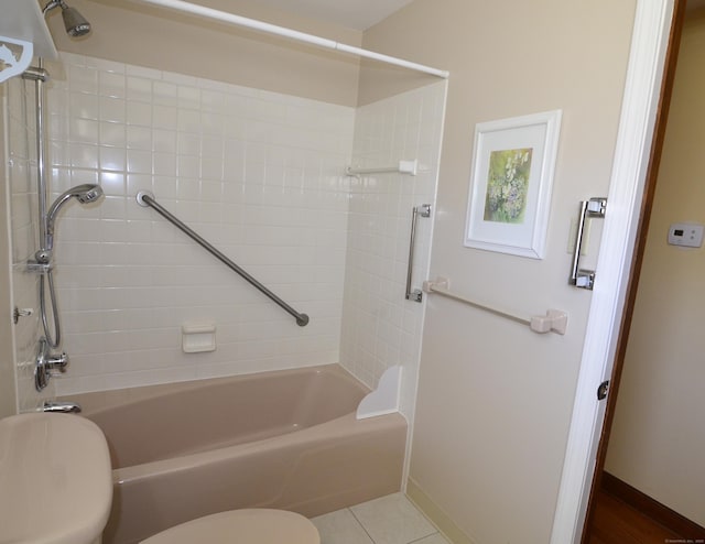 bathroom with toilet,  shower combination, baseboards, and tile patterned flooring