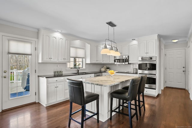 kitchen featuring stainless steel appliances, a wealth of natural light, and white cabinetry