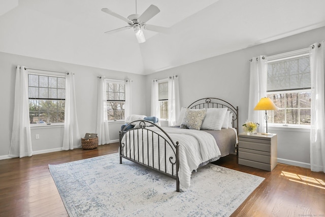 bedroom featuring dark wood finished floors, vaulted ceiling, ceiling fan, and baseboards