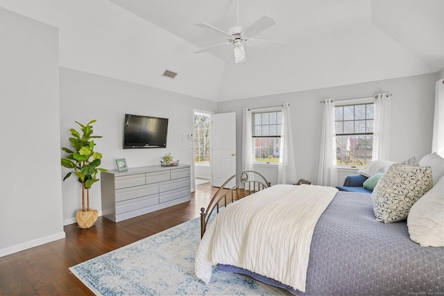 bedroom with lofted ceiling, wood finished floors, visible vents, a ceiling fan, and baseboards