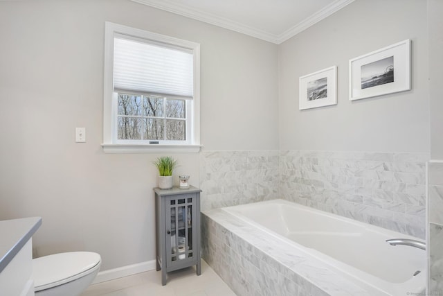 full bathroom with toilet, baseboards, tile patterned flooring, a garden tub, and ornamental molding