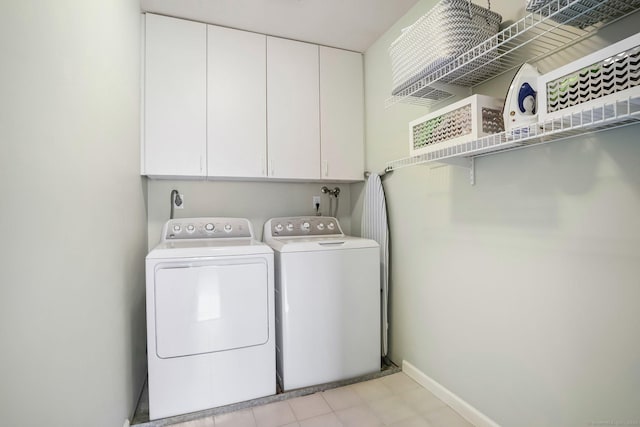 clothes washing area featuring washing machine and clothes dryer and baseboards