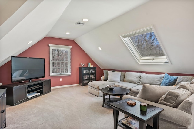 living room with lofted ceiling with skylight, baseboards, visible vents, recessed lighting, and light colored carpet