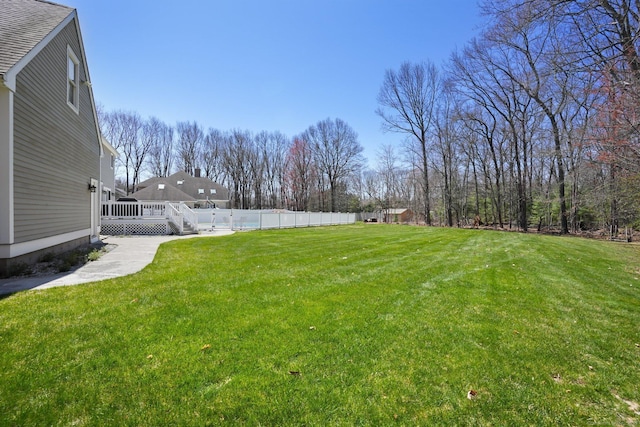 view of yard with fence and a deck