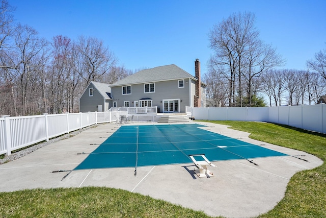 view of swimming pool with a fenced backyard, a fenced in pool, and a deck