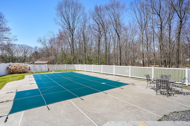 view of pool featuring fence and a patio
