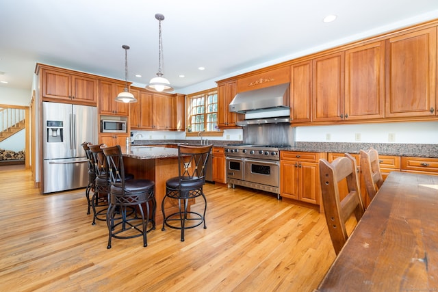 40 Old Bridge Rd, Brookfield, CT 06804 - kitchen featuring brown cabinets, light wood-type flooring, wall chimney exhaust hood, and stainless steel appliances