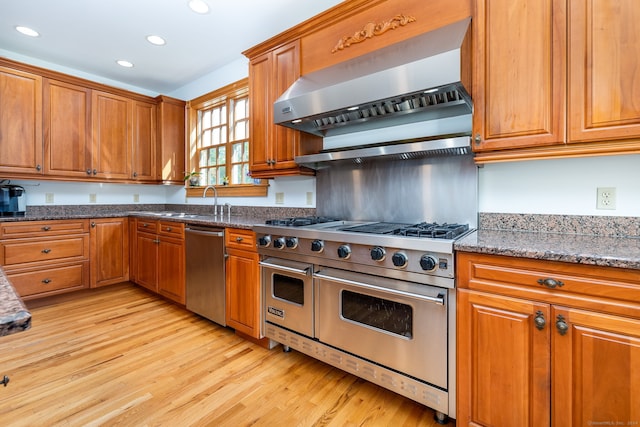 40 Old Bridge Rd, Brookfield, CT 06804 - kitchen with brown cabinets, recessed lighting, wall chimney exhaust hood, and stainless steel appliances