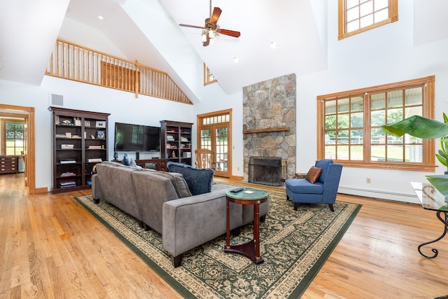 40 Old Bridge Rd, Brookfield, CT 06804 - living room with high vaulted ceiling, a ceiling fan, a stone fireplace, visible vents, and a baseboard radiator
