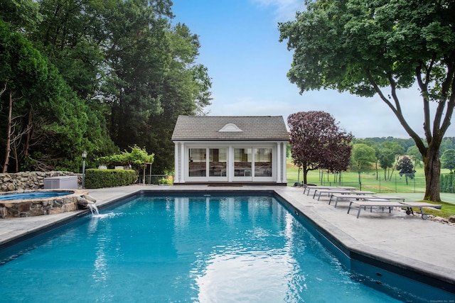 77 Eastfield Rd, Waterbury, CT 06708 - view of swimming pool featuring a patio, an exterior structure, a pool with connected hot tub, an outbuilding, and fence